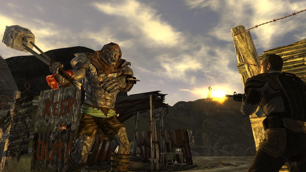 Fallout: New Vegas: A power-armored figure faces a ruined settlement at sunset.